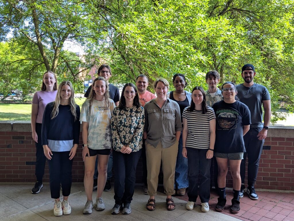 Paradine group photo: group of 13 chemists, in two rows, standing in front of some trees
