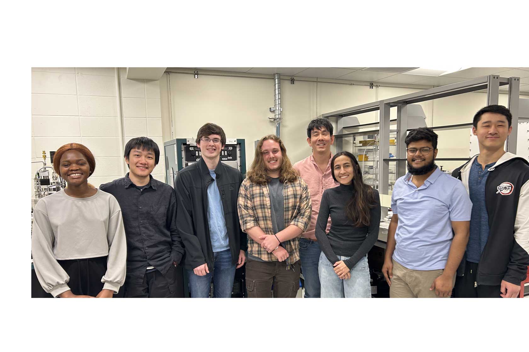 A diverse group of individuals collaborating in a laboratory setting, surrounded by scientific equipment and research materials.