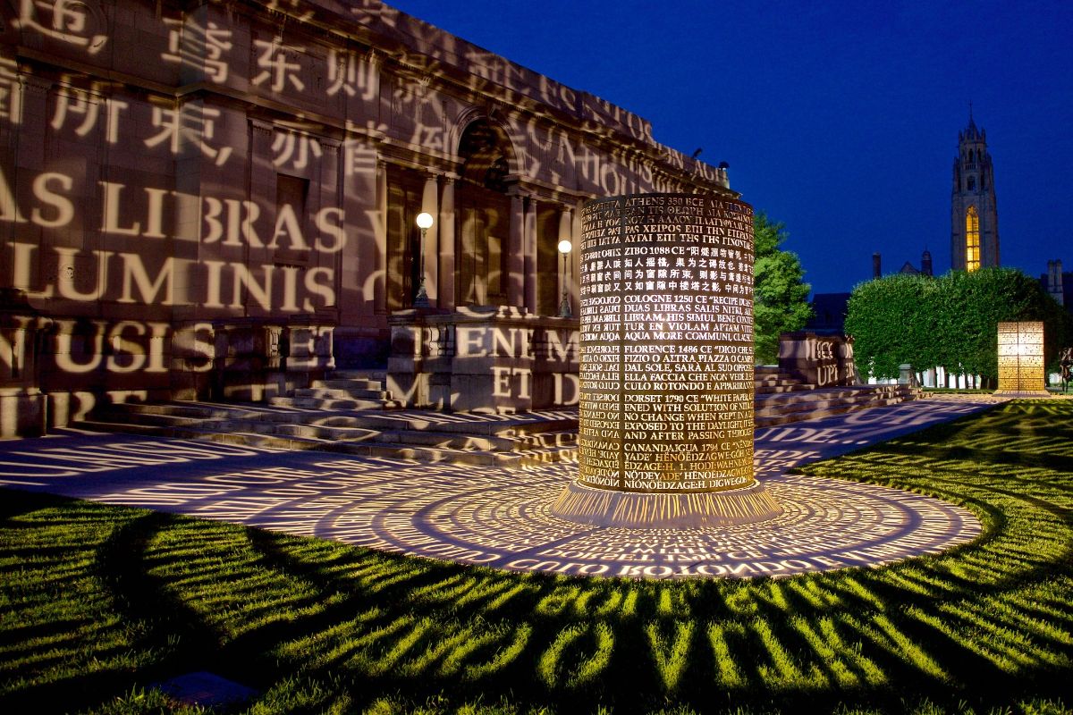 Illuminated sculpture of words projected onto the ground at the University of Rochester's Memorial Art Gallery installation.